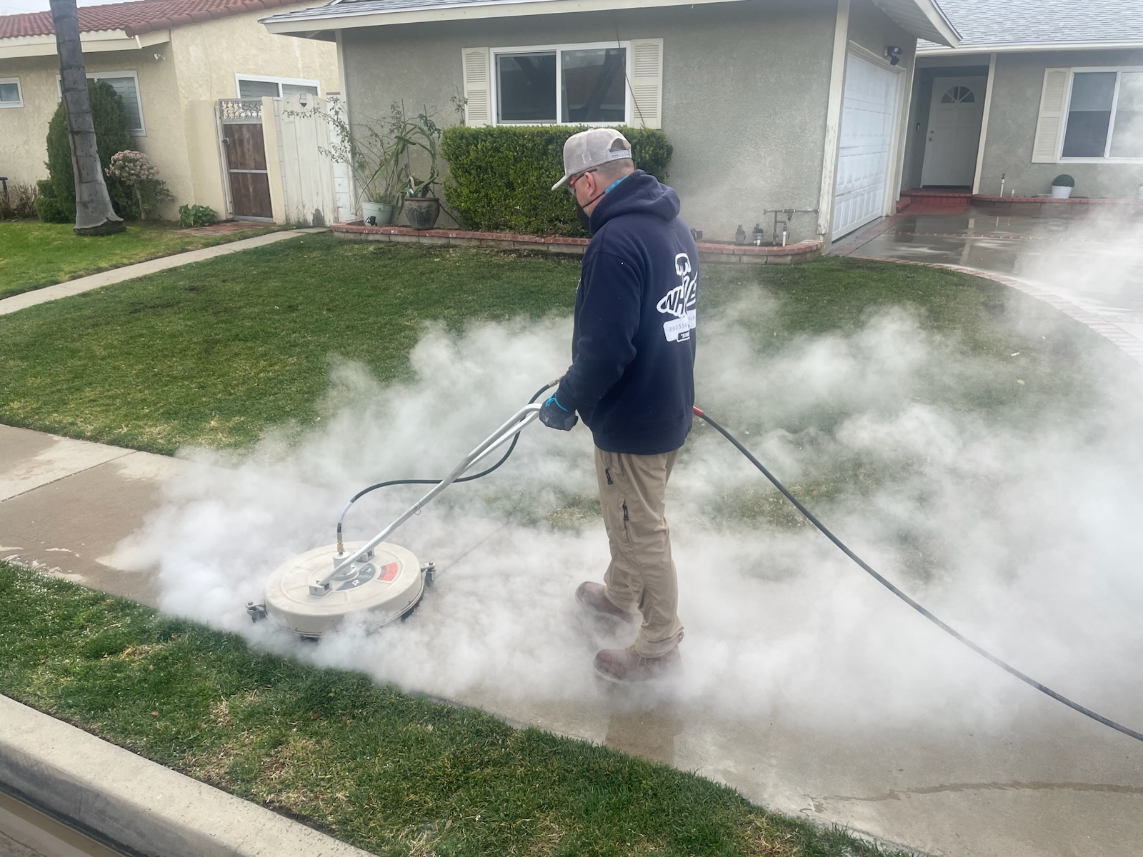 Steam cleaning a residential walkway